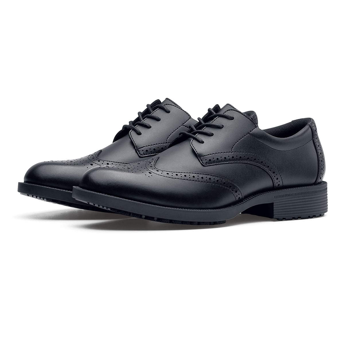 The Executive Wing Tip IV from Shoes For Crews, is an slip resistant dress shoe with a water resistant breathable leather upper to provide industry leading levels of grip and durability, pair seen in profile on the left.