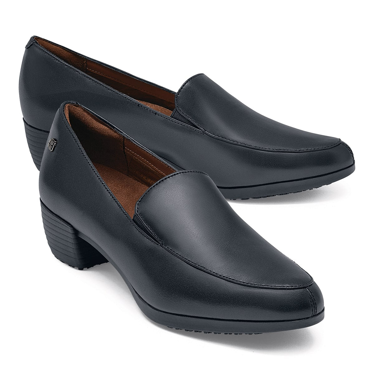 The Envy III Wide from Shoes For Crews is a slip-resistant shoe made with a durable, water-resistant leather upper, pair seen in profile on the right.