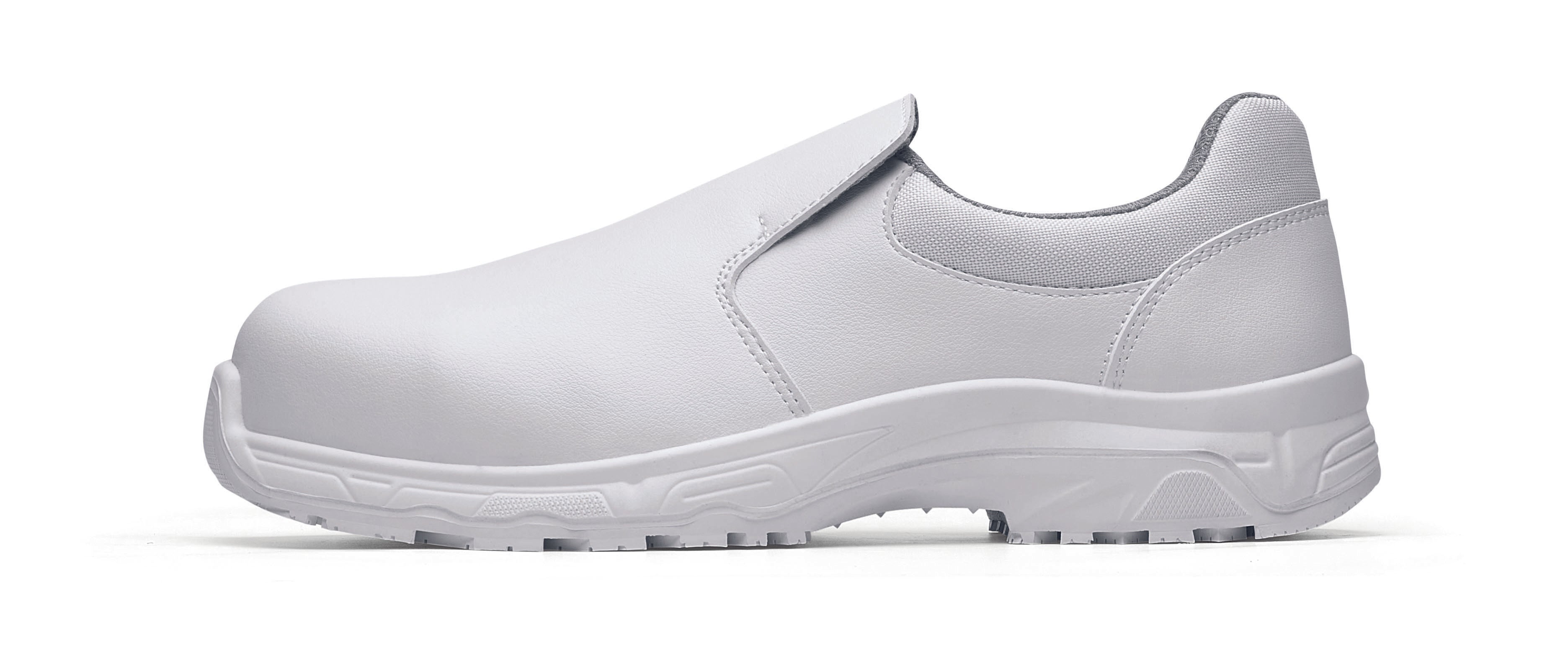 The Catania White from Shoes For Crews, made in Italy, is a slip-resistant shoe with a composite safety toe cap and a puncture-resistant midsole, seen from the left.
