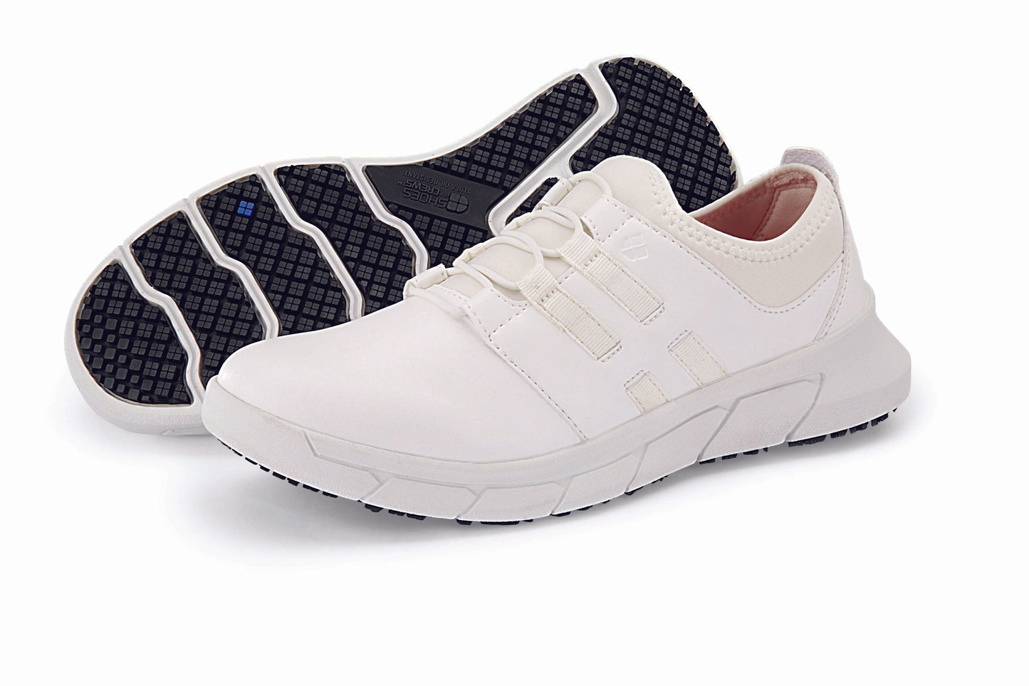 The Karina White by Lila from Shoes For Crews are black slip-resistant trainers that are lightweight and have Flex Tread technology, pair seen from the left side and the sole.