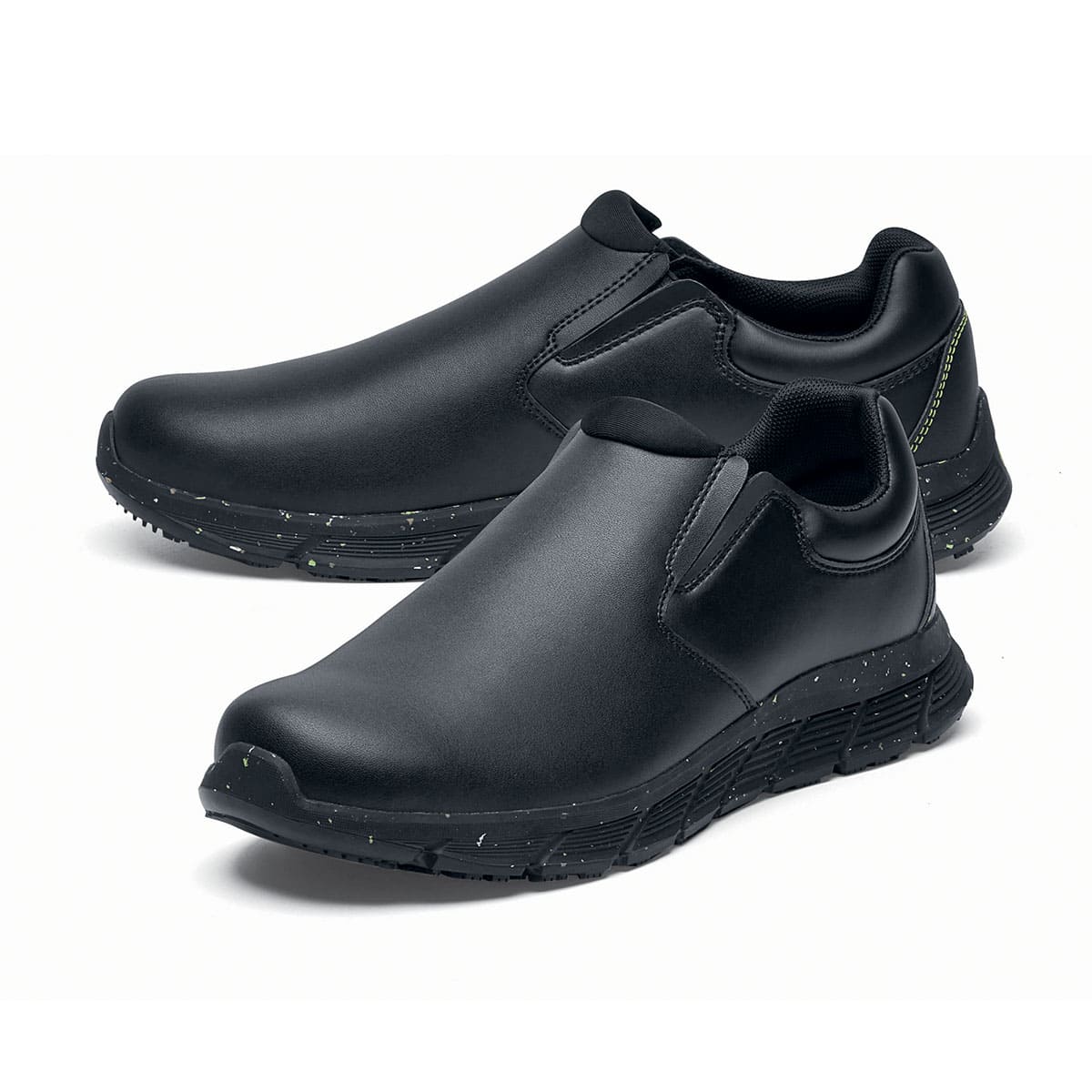 The Shoes for Crews Cater Eco Women's Black is a sustainable, slip-resistant safety shoe, pair seen from the left side, emphasised on the tip of the left shoe.
