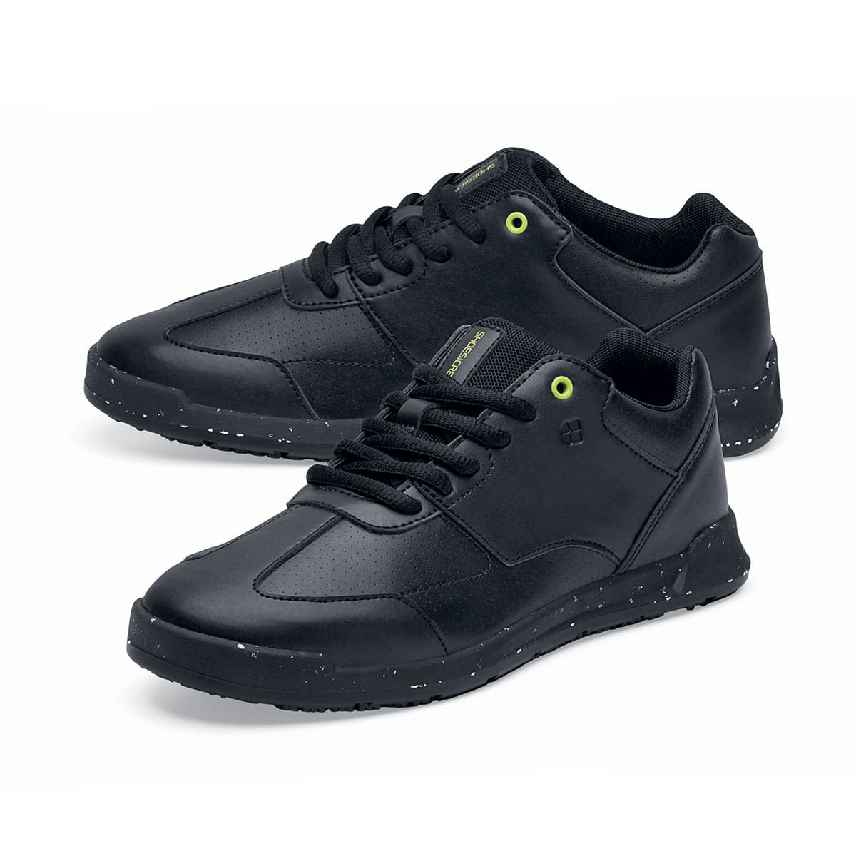 The Liberty Eco from Shoes For Crews are sustainable, slip-resistant trainers that provide comfort and safety throughout the day, pair seen from the left side, emphasised on the tip of the left shoe.