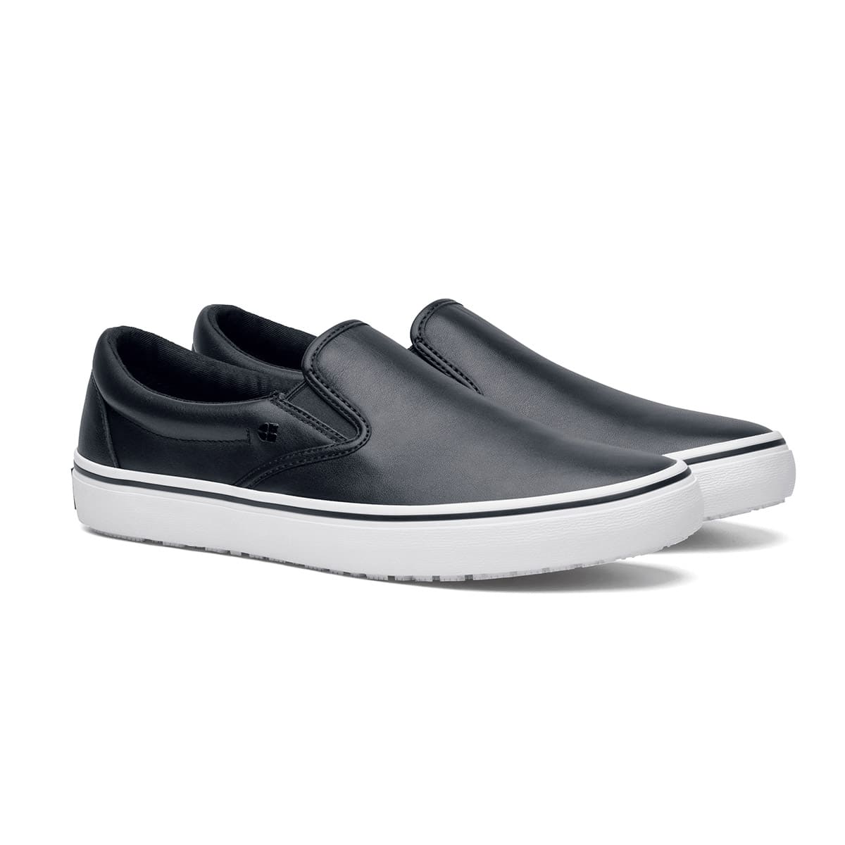 The Merlin Slip On Black and White from Shoes For Crews are slip-on trainers that are slip-resistant, lightweight, easy to clean and water-resistant, pair seen in profile on the right.