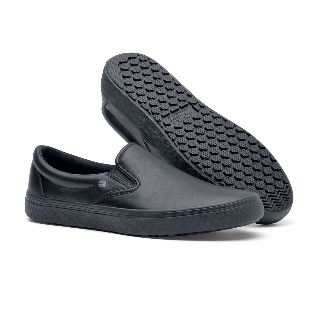The Merlin Black from Shoes For Crews are slip-on slip resistant shoes with a lightweight design and constructed from genuine leather that has been specially treated to repel liquids from the surface, pair seen from the right side and the sole.