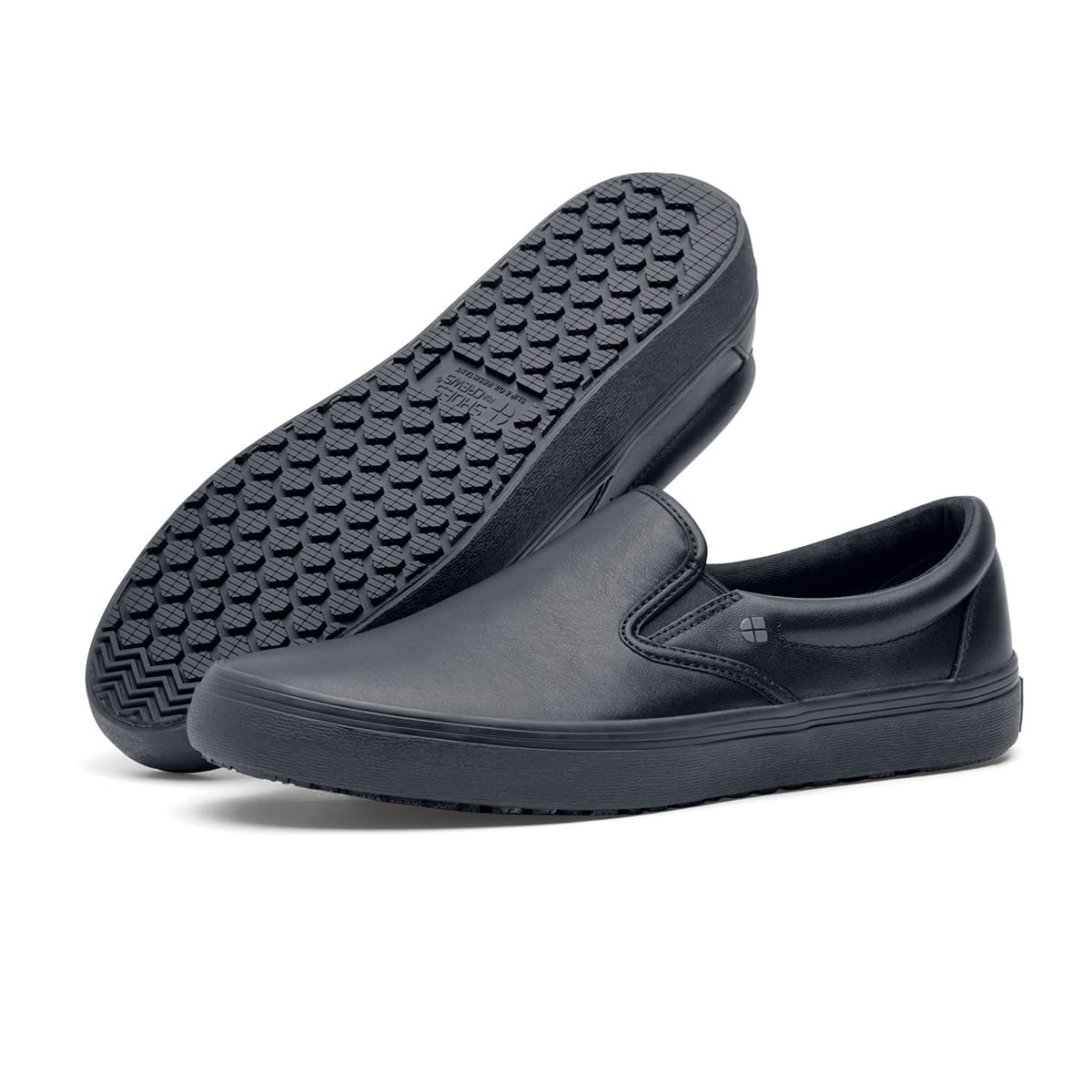 The Merlin Black from Shoes For Crews are slip-on slip resistant shoes with a lightweight design and constructed from genuine leather that has been specially treated to repel liquids from the surface, pair seen from the left side and the sole.