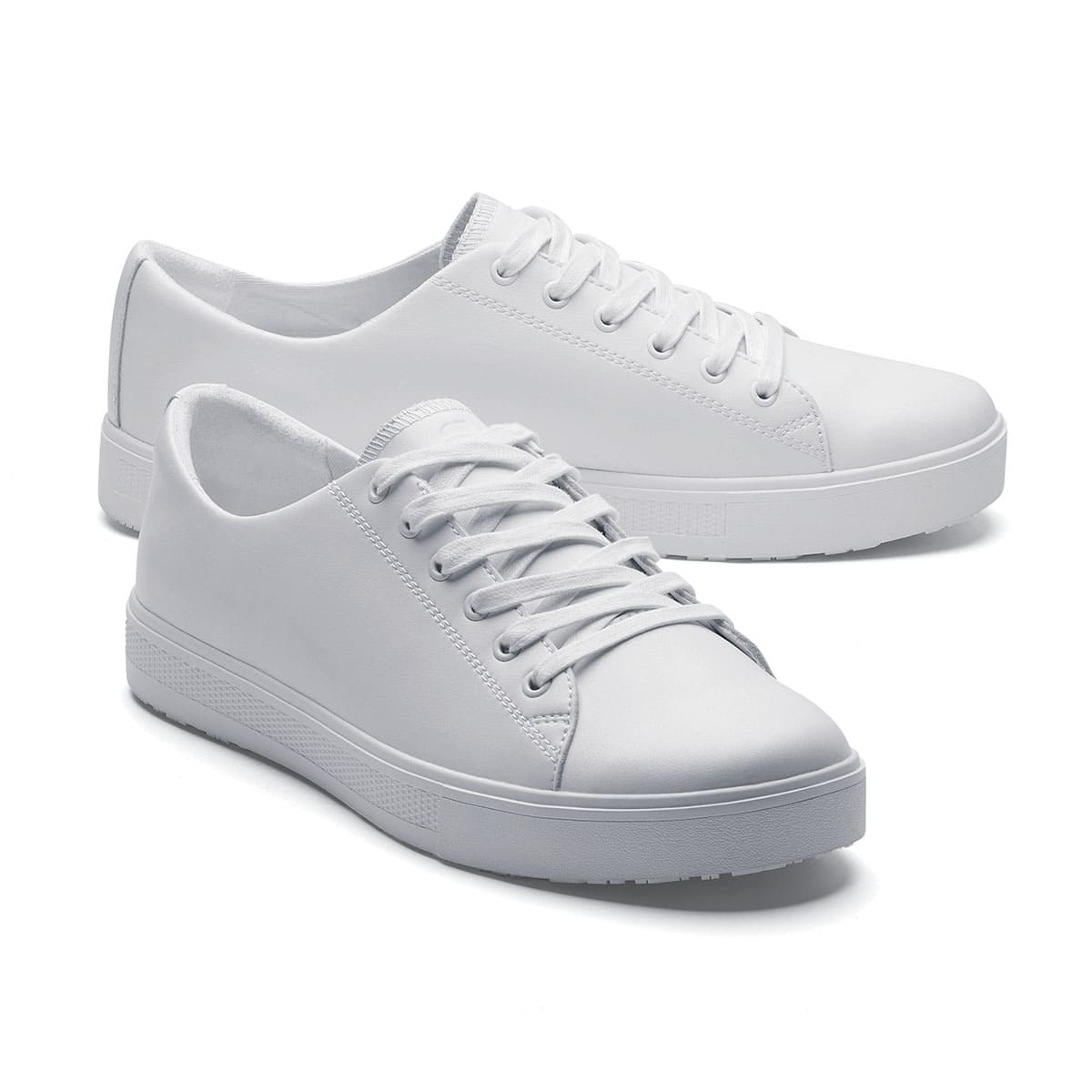 The Old School Low-Rider White from Shoes For Crews is a slip resistant lace-up designed to provide comfort throughout the day, pair seen from the right side, emphasised on the tip of the right shoe.