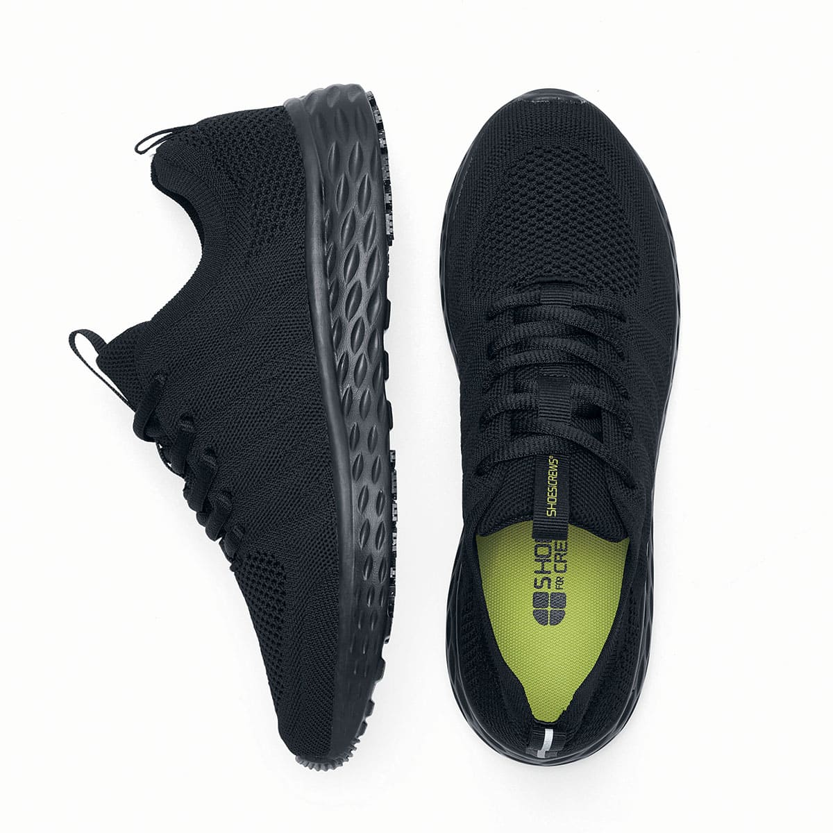 The Everlight™ Eco Men's Black from Shoes For Crews are slip-resistant trainers built with a recycled mesh upper that is water-resistant and breathable. Designed to keep your feet cool and ventilated, viewed from the side and bottom at a vertical angle.