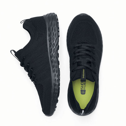 The Everlight™ Eco Men's Black from Shoes For Crews are slip-resistant trainers built with a recycled mesh upper that is water-resistant and breathable. Designed to keep your feet cool and ventilated, viewed from the side and bottom at a vertical angle.
