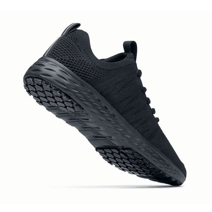The Everlight™ Eco Men's Black from Shoes For Crews are slip-resistant trainers built with a recycled mesh upper that is water-resistant and breathable. Designed to keep your feet cool and ventilated,  seen from the perpendicular.