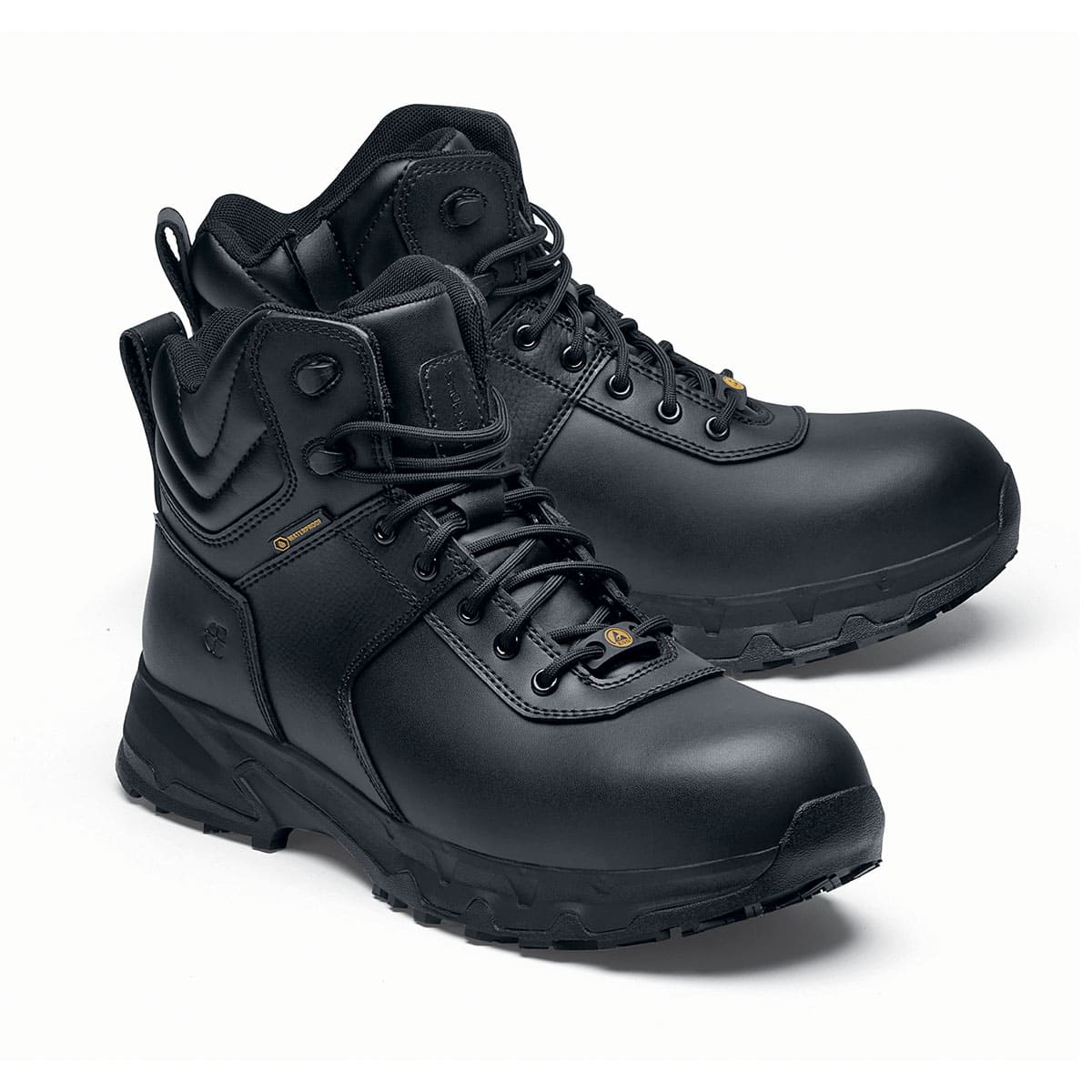 The Guard Mid from Shoes For Crews are waterproof slip-resistant safety boots with a safety toe cap, pair seen from the right side, emphasised on the tip of the right shoe.