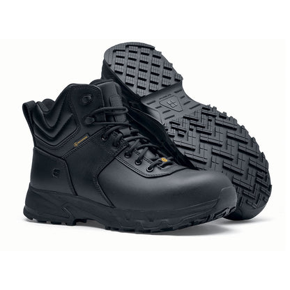 The Guard Mid from Shoes For Crews are waterproof slip-resistant safety boots with a safety toe cap, pair seen from the right side and the sole.
