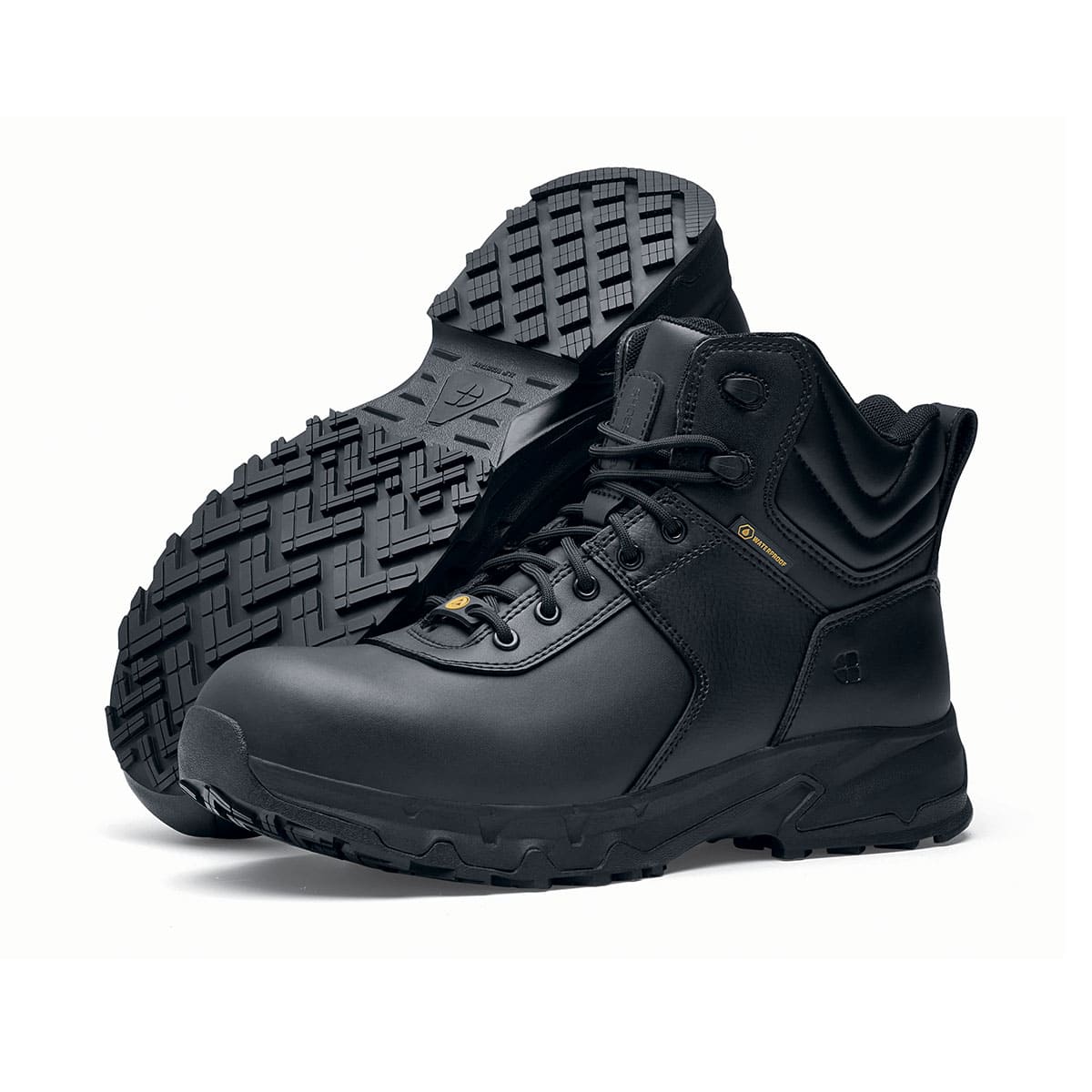 The Guard Mid from Shoes For Crews are waterproof slip-resistant safety boots with a safety toe cap, pair seen from the left side and the sole.